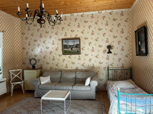 a living room with a couch and a table at VILLA ANNA in Naantali