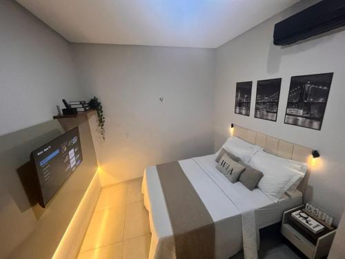 a bedroom with a bed and a flat screen tv at WA Espaco e Lazer in Barbalha