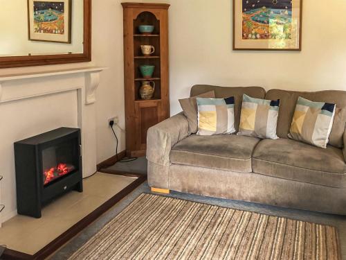 a living room with a couch and a fireplace at The Lodge in Uny Lelant