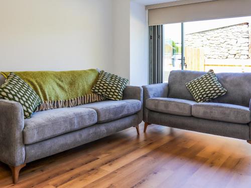 a living room with a couch and a chair at Bodlyn - Uk48861 in Llanddwywe