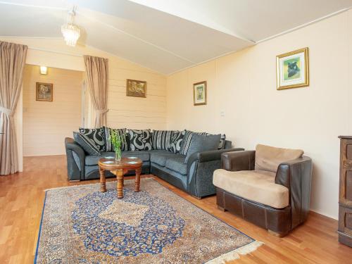 a living room with a couch and a chair at 2 The Folly's - Uk45188 in Abbotskerswell
