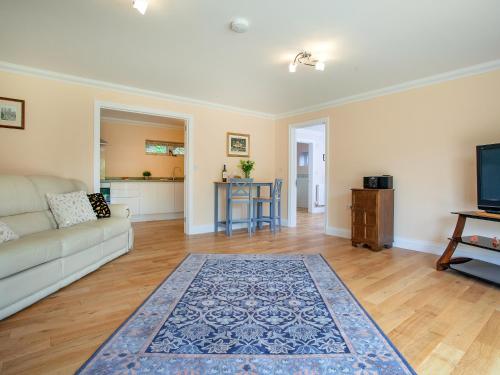 a living room with a couch and a table at 1 The Folly's - Uk45189 in Abbotskerswell