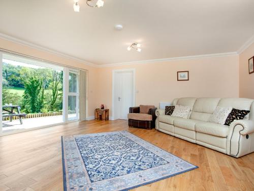 a living room with a couch and a table at 1 The Folly's - Uk45189 in Abbotskerswell