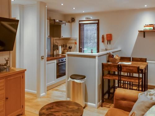 a kitchen with a counter and a table in a room at The Wooden Lodge in Byton