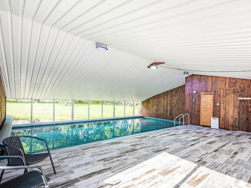 an indoor swimming pool in a building with a ceiling at Stuarts Farm Barn in Westhead