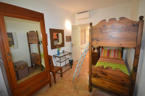 a bedroom with two bunk beds and a mirror at La Lomita in Santa Marinella