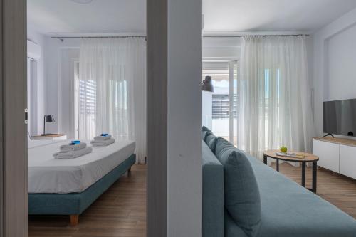 a bedroom with a bed and a living room at SLV Roxani Apartment in Ofrínion