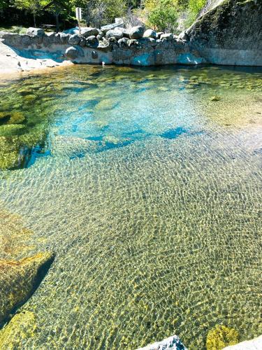a large body of water with rocks and minerals at Interbeira Sandomil River Cottage in Seia