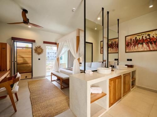 a bathroom with a sink and a living room at Samawa Living in Paje