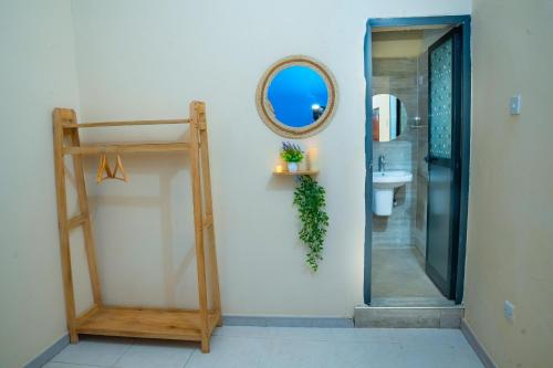 a bathroom with a mirror and a sink at Golden Nap hostel in Zanzibar City