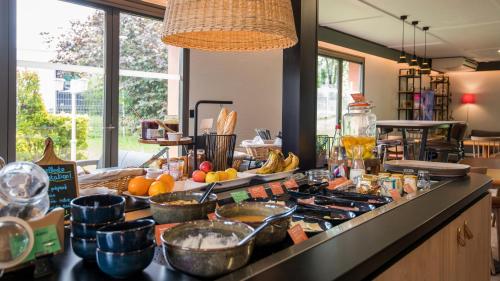 a kitchen with a counter top with a stove top at Campanile NATURE - Brive-la-Gaillarde in Brive-la-Gaillarde