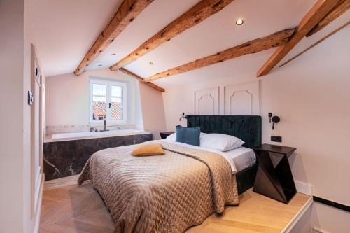 a bedroom with a bed and a bathroom with a sink at Villa Ofellia in Dubrovnik