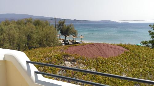 a view of the ocean from a balcony of a resort at Oasis studios in Psili Ammos