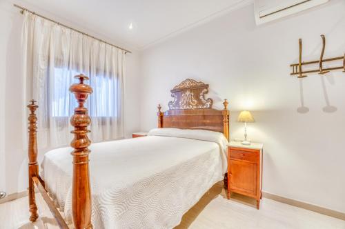a bedroom with a large wooden bed and a window at Ideal Property Mallorca - Can Peret in Sa Pobla