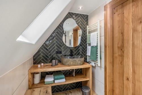 a bathroom with a sink and a mirror at Tannenhäuschen Sauerland in Schmallenberg
