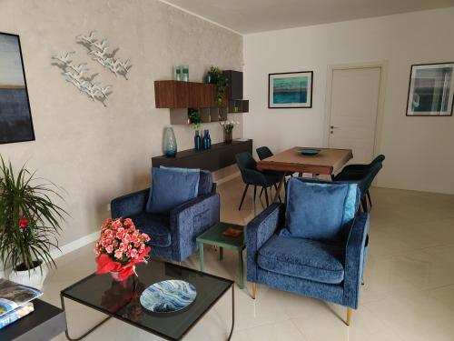 a living room with two blue chairs and a table at Villa Silvana in Lecce