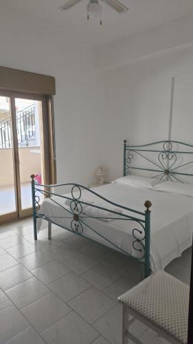 a bedroom with a bed and a window at CASA VACANZE ANDREANA in Letojanni