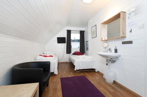 a room with two beds and a sink in it at Stavanger Bed & Breakfast in Stavanger
