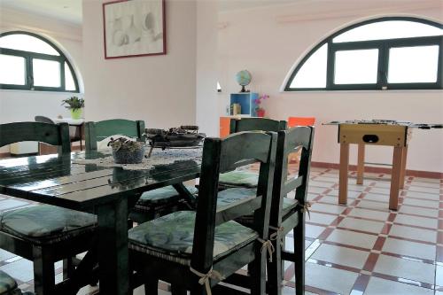 a dining room with a wooden table and chairs at Sea Breeze Apartment in Korakokhórion