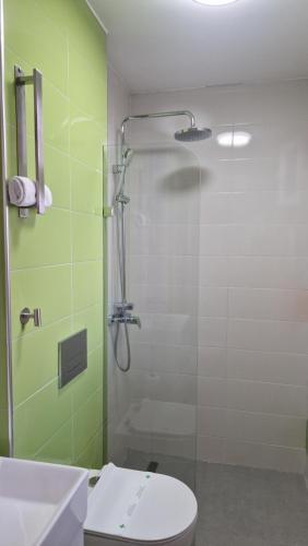 a bathroom with a shower with a toilet and a sink at Waterside Houses in Ognyanovo