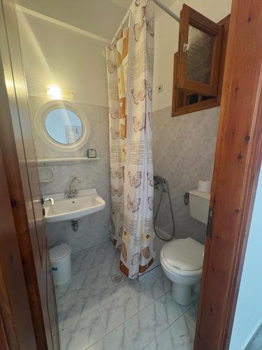 a bathroom with a toilet and a sink at Summer Time in Ios Chora