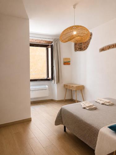 a bedroom with a bed and a window at Dimora Febo in Centro Storico in Piombino