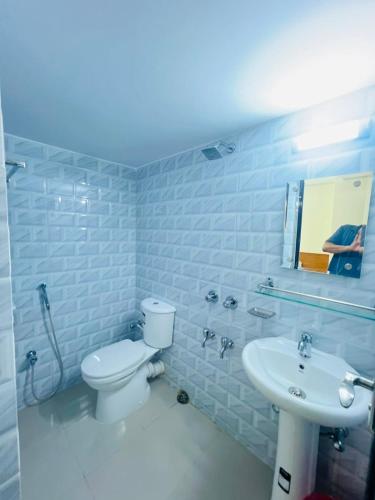 a bathroom with a toilet and a sink at Hotel Comfort Inn Sylhet in Sylhet