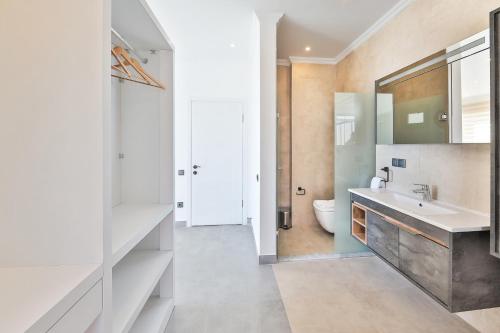 a bathroom with a sink and a toilet at SHB Villas Kalkan in Kaş