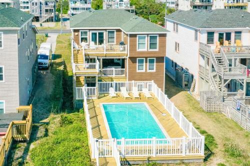 an aerial view of a house with a swimming pool at Dream Catcher - Nags Head MP 12, Oceanfront, Elevator, Pool, Hot Tub, Pets OK, YR Flex in Nags Head