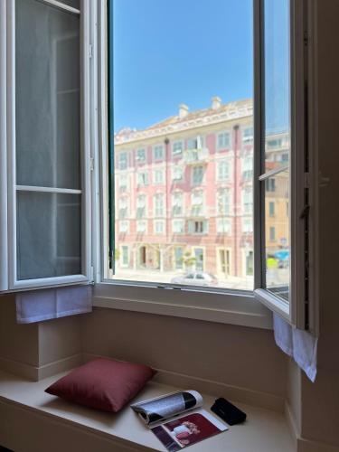 a window with two phones and a book on a window sill at Hotel Fernanda in Rapallo