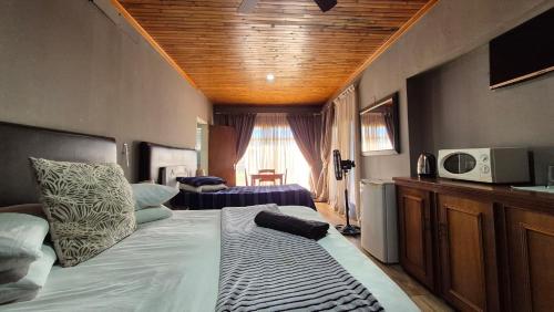a bedroom with a large bed in a room at Silhouette Guesthouse in Welkom