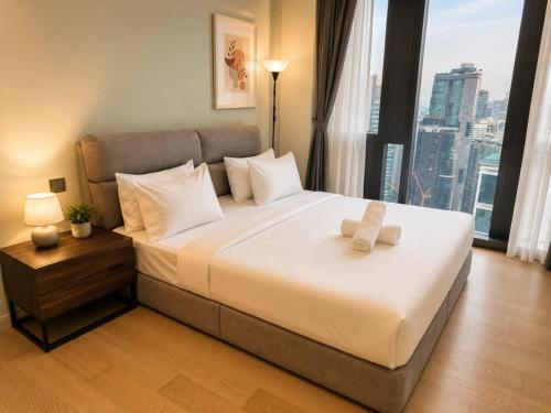 a bedroom with a large bed with a large window at Star Sky Park KLCC in Kuala Lumpur