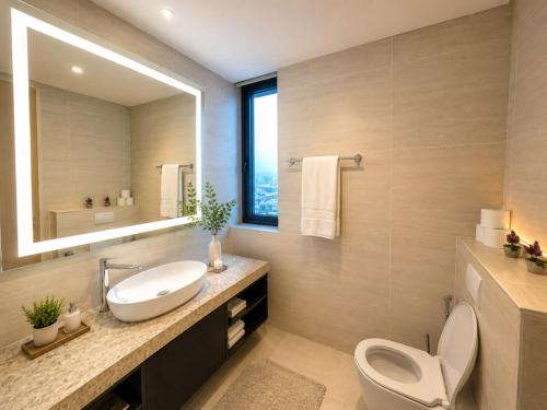 a bathroom with a sink and a toilet and a mirror at Star Sky Park KLCC in Kuala Lumpur