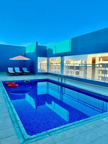 a large swimming pool on top of a building at Saffron Hotel and Lounges in Muscat