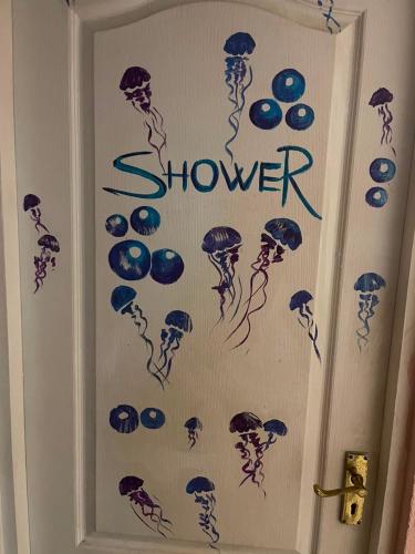 a door with stickers on it with the word shower at Good driams Xoctel in Kyiv