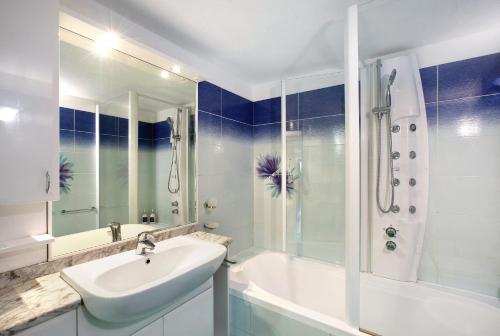 a white bathroom with a sink and a shower at Chalet vista Monte Bianco in La Salle