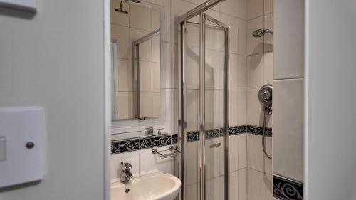 a bathroom with a shower and a sink at Hallbottom Farm Cottage in Stokenchurch