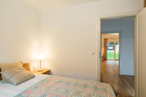 a bedroom with a bed and a lamp on a table at Appartment am Mondsee in Mondsee