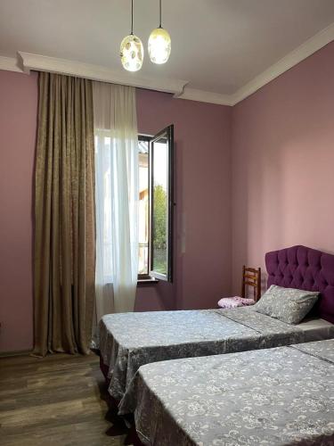 a bedroom with two beds and a window at Hotel Odabade in Zugdidi