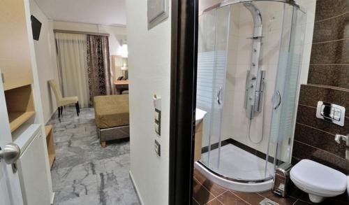 a bathroom with a shower and a toilet in a room at Lintzi Hotel in Arkoudi