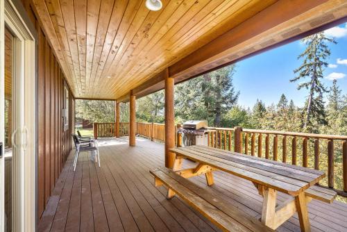 a wooden porch with a bench on a deck at Glacier River Ranch - Flathead in Columbia Falls