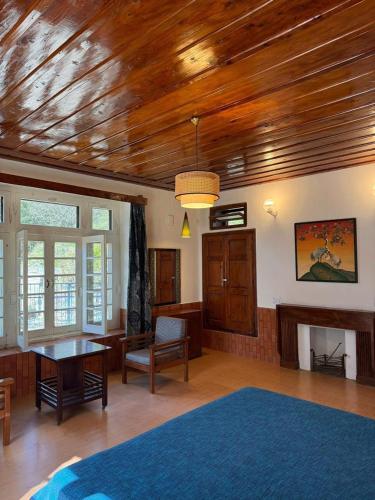 a large living room with a wooden ceiling at Deodar Manor - Guest House Khajjiar in Khajjiar 