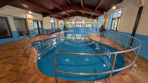 a large swimming pool in a building at 35 Strawberry Hill, Tolroy Manor in Hayle