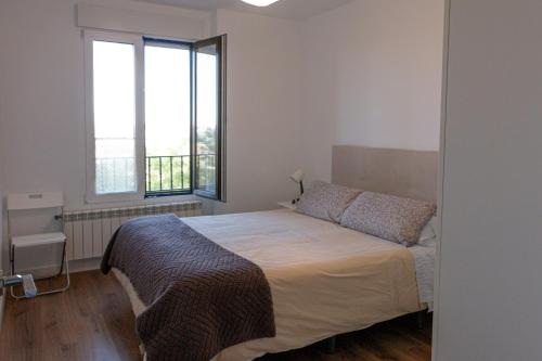 a bedroom with a bed and a large window at El Carmen in Toro