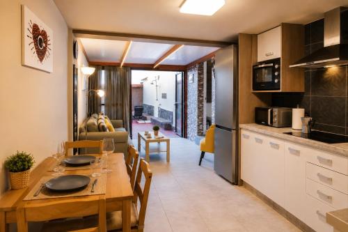 a kitchen and living room with a wooden table and a dining room at Private Terrace, Residential Area, Beach & Surf, El Médano in El Médano