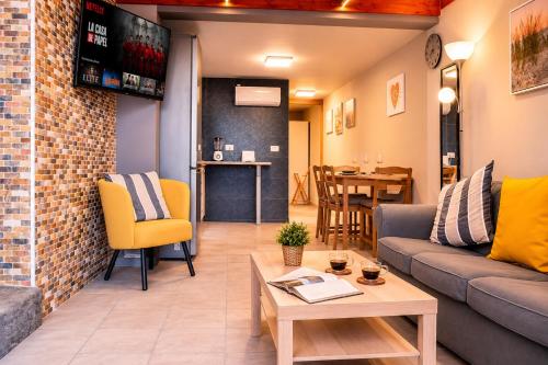 a living room with a couch and a table at Private Terrace, Residential Area, Beach & Surf, El Médano in El Médano