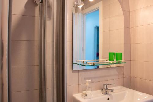 a bathroom with a sink and a mirror and a shower at El Carmen in Toro