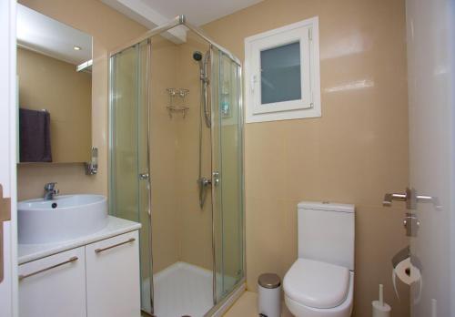 a bathroom with a shower and a toilet and a sink at SeaBreeze City Center Flat by TrulyCyprus in Limassol