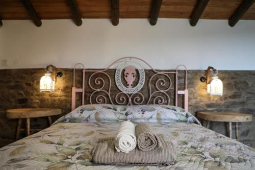 a bedroom with a bed with two towels on it at Casa da Moleira in Chaveirinha