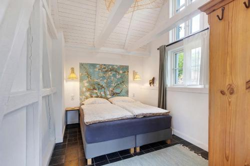 a bedroom with a bed in a room with a window at Gästehaus Altes Forstamt Sinntal in Sinntal